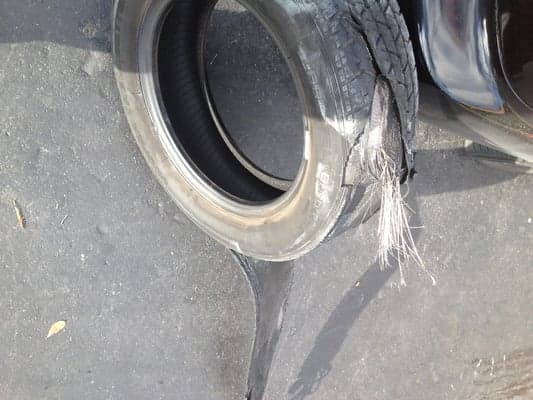 A worn tire showing the kind of damage Quick Tire repairs every day